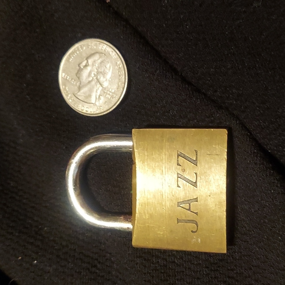 Dope vintage brass lock. Customized with "jazz" engraving. Fun trinket. Pendant?